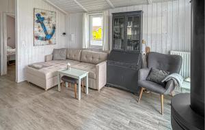 a living room with a couch and a table and chairs at Friedrichskoog-Deichblick 4 in Friedrichskoog