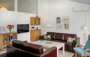 a living room with a leather couch and a table at Golfparken in Aabenraa