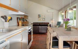 a kitchen with a table and a living room at Golfparken in Aabenraa