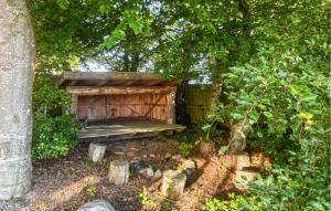a wooden bench sitting under a tree at Nice Home In Haderslev With Wifi in Haderslev