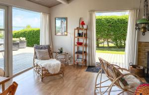 a living room with chairs and a sliding glass door at Nice Home In Børkop With Wifi in Børkop