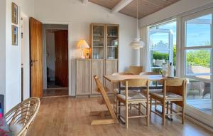 a dining room with a table and chairs and a window at Nice Home In Børkop With Wifi in Børkop