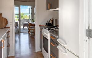 a kitchen with a stove top oven next to a door at Nice Home In Børkop With Wifi in Børkop
