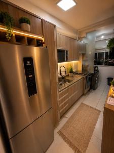 a large kitchen with a stainless steel refrigerator at Recanto Augusta in Londrina