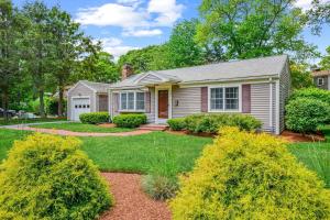 a small white house with a yard at Cozy Cape Escape Near Beaches Dining in Centerville