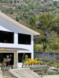 a white house with stairs in front of it at Los Lirios Hotel Merida in Mérida