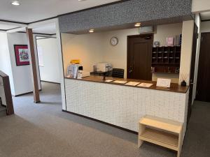 a restaurant with a counter with a table and a counter sidx sidx at Pension Lavender in Furano