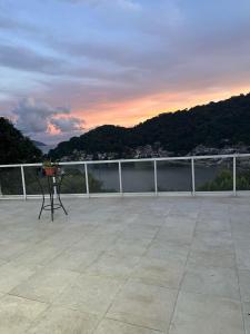 a balcony with a table and a view of the water at Coffehouse - Casa com Piscina in São Vicente +2 photos