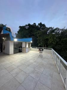 a large patio with a table on a balcony at Coffehouse - Casa com Piscina in São Vicente