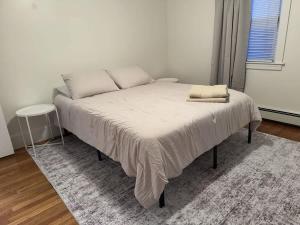 a bed with two pillows on it in a bedroom at Comfortable 4 Bed Home close to Gillette in Foxborough