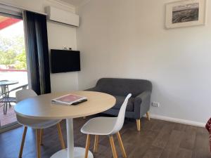 a living room with a table and a couch at Cobar Caravan Park in Cobar