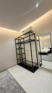 a room with a mirror and a room with a bed at نُزل البدر - غرفة و صالة دخول ذاتي in Al Kharj