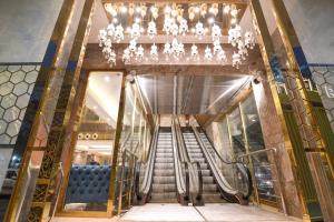 a staircase in a building with a chandelier at Kzar Central in Kolkata