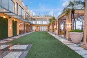 an internal courtyard of a building with a green lawn at Kzar Central in Kolkata