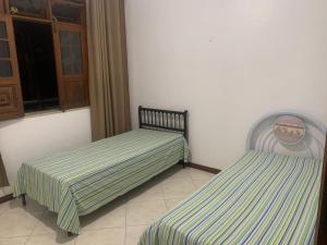 two beds sitting next to each other in a room at Quartos petrolina 02 in Petrolina +6 photos