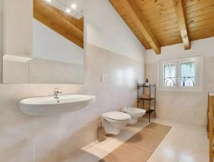 a white bathroom with a sink and a toilet at Mansarda Spadone in Musso +17 photos