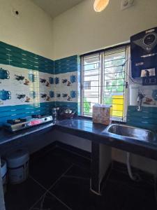 a small kitchen with a sink and a window at 101 Mahalaxmi Homes in Bhubaneshwar