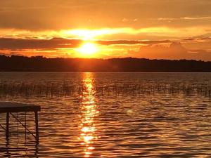 a sunset over a large body of water at New, condo stunning Lake View in Bellaire