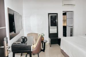 a hotel room with a bed and a desk with a computer at ModexD'Crib in Lagos