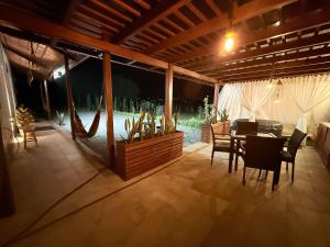 a dining area with a table and chairs on a patio at La Cabaña de Ciela C glamping con jacuzzi , minigolf y croquet in Latacunga