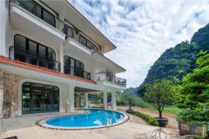 an exterior view of a house with a swimming pool at Heritage Charm Hotel Trang An in Ninh Binh