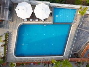 an overhead view of a swimming pool with umbrellas at Hotel Dachi Kathmandu - Bhaktapur in Bhaktapur
