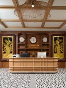 an office with clocks on the wall and a desk at Heritage Charm Hotel Trang An in Ninh Binh