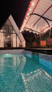 a swimming pool at night with lights on top of it at Central Suites in Tarapoto
