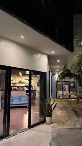 a house with glass doors with a bed in the background at Central Suites in Tarapoto +4 photos