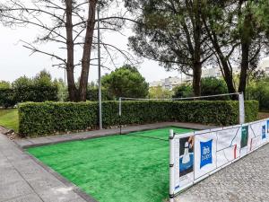 a golf course with green grass on a sidewalk at Hotel ibis Budget Porto Gaia in Vila Nova de Gaia