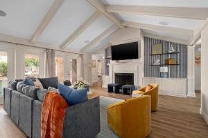 a living room with a couch and chairs and a tv at SolMaré - 5BR, Pool, Spa, Mini-Golf, Outdoor Kitchen, Fire Pit, Game Room in Bradenton