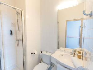 a bathroom with a toilet and a sink and a shower at ibis budget Le Mans Centre in Le Mans +44 photos