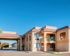a large apartment building with a garage at Rodeway Inn Tucumcari in Tucumcari