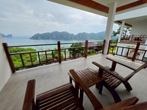a balcony with benches and a view of the ocean at PP Mountain Beach Resort in Phi Phi Islands