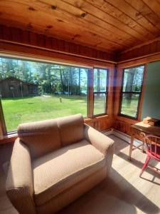 a living room with a couch and a table and windows at Black Hawk in Mercer +9 photos