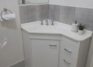 a bathroom with a white sink and a shower at Flaxton Country Lodge in Flaxton