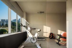 a room with a exercise bike and a window at SOVIS PLUS HOTEL in Shenzhen