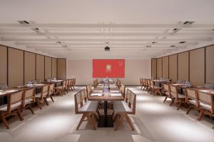 a dining room with tables and chairs and a redboard at SOVIS PLUS HOTEL in Shenzhen