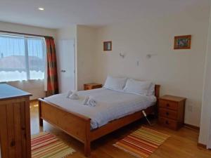 a bedroom with a large bed and a window at Coastal, Spacious, Mountain Views - KK21238 in Kaikoura