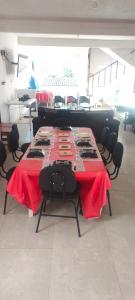 a table with a red table cloth on it in a room at Casa branca in Aracaju