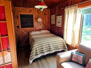 a bedroom with a bed in a wooden room at Black Hawk in Mercer
