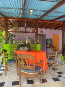 a dining room with a table and chairs at Cozy cabin by the sea in Cahuita