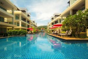 a swimming pool in front of some buildings at Krabi One Bedroom Pool View in Klong Muang Beach