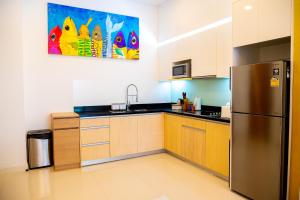 a kitchen with a stainless steel refrigerator and cabinets at Krabi One Bedroom Pool View in Klong Muang Beach