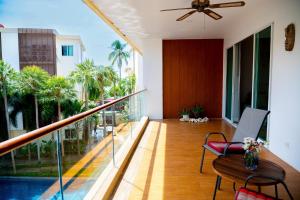 a balcony with a table with a laptop on it at Krabi One Bedroom Pool View in Klong Muang Beach