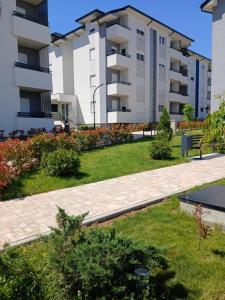 a park in front of a apartment building at Natura Lux & Parking Free - Green Hill, blizu Akva parka in Soko Banja