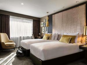 a hotel room with two beds and a chair at Sofitel Wellington in Wellington +118 photos