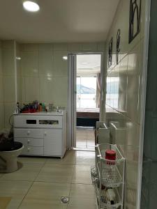 a kitchen with a sink and a counter with a window at Meneghetti Mangaratiba in Mangaratiba +36 photos