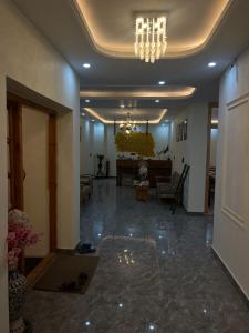 a lobby with a chandelier and a living room at Snow Den hostel in Leh