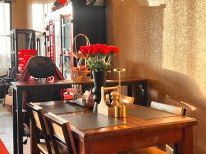 a wooden table with a vase of red flowers on it at LECAR Home Mustang in Ban Nong Khang +3 photos